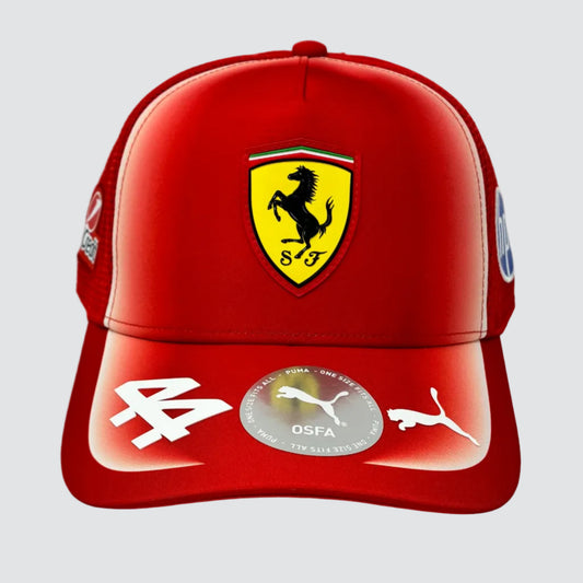A red Ferrari baseball cap featuring the yellow Scuderia Ferrari shield logo on the front, with white Puma logos on the brim and a circular OSFA sticker in the center.